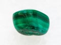 tumbled Malachite gemstone on white marble Royalty Free Stock Photo