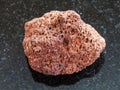 tumbled red pumice stone on dark background Royalty Free Stock Photo