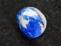 tumbled Sodalite gem stone on dark