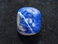 tumbled Sodalite gemstone on dark background