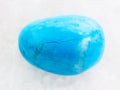 tumbled Turquenite (blue howlite) stone on white