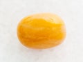 tumbled yellow jasper gemstone on white