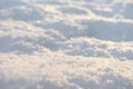 Macro shot background of fresh white snow at the sunset. Snowflakes texture. Snow texture winter background. Shiny snow with bokeh Royalty Free Stock Photo