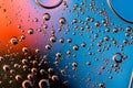 Macro shot of backlit liquid with small bubbles in it over colored background Royalty Free Stock Photo