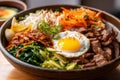 macro shot of Bibimbap deliciously seasoned and grilled beef, paired with a vibrant assortment of vegetables and a runny egg