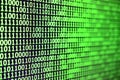 Macro shot of binary code on the monitor of an office computer. The concept of the programmer`s work. The flow of digital informa Royalty Free Stock Photo