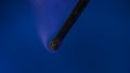 Macro shot of a black charred match and clouds of white smoke. Burned extinguished wooden match on dark studio