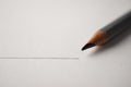 Macro shot of black pencil graphite with drawing line on textured white paper Royalty Free Stock Photo