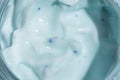 Macro shot of blue liquid cream cosmetic with micro capsules microsphere. texture in glass jar close up Royalty Free Stock Photo
