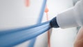 Macro Shot of a Blue Marker Pen Being Held with a Hand. Person Drawing a Blue Line on a Royalty Free Stock Photo