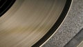 Macro shot of brown vinyl record with grooves. An old gramophone record. Vintage vinyl record player. Retro background Royalty Free Stock Photo