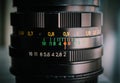 Macro shot of a camera lens focusing on camera lens information the aperture size Royalty Free Stock Photo