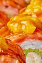 Macro shot of caramelized mango pieces on seared salmon slice on sushi roll Royalty Free Stock Photo