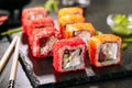 Macro shot of chicken maki sushi rolls with rice, cream cheese, chicken fillet, tomato, cucumber, red flying fish caviar and nori. Royalty Free Stock Photo