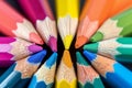 Macro shot of color pencils tipped nibs arranged diagonally, desk