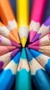 Macro shot of color pencils tipped nibs arranged diagonally, desk