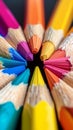 Macro shot of color pencils tipped nibs arranged diagonally, desk