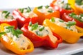 Macro shot of colorful stuffed mini sweet peppers filled with tangy cream cheese and topped with fresh chives Royalty Free Stock Photo