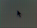 Macro shot of computer mouse pointer with RGB pixels visible
