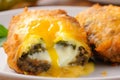 Macro shot of crispy golden Chiles Rellenos battered with egg and stuffed with savory ground beef