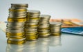 Macro shot detail of golden and silver color coin stacks on with banknotes . Business and finance growth, saving money, investmen Royalty Free Stock Photo