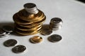 Macro shot detail of golden and silver color coin stacks on dark