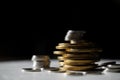 Macro shot detail of golden and silver color coin stacks on dark