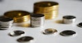 Macro shot detail of golden and silver color coin stacks on dark