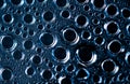 Macro shot detail of water drops with unique pattern. Water drops texture background. Round shape of droplet on dark background. Royalty Free Stock Photo