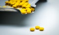 Macro shot detail of yellow round sugar coated tablets pills on Royalty Free Stock Photo