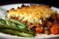 Macro shot of a dish of Shepherd pie with a crispy and golden panko breadcrumb topping, served with a side of green beans