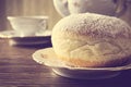 Macro shot of donut with cup of coffee on table in old-style Royalty Free Stock Photo