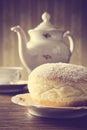 Macro shot of donut with cup of coffee on table in old-style Royalty Free Stock Photo