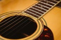 Macro shot down the fretboard of acoustic guitar with shallow depth of field Royalty Free Stock Photo