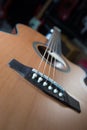 Macro shot down the fretboard of acoustic guitar with shallow depth of field Royalty Free Stock Photo