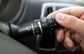 Macro shot of driver adjusting windscreen wipers control toggle Royalty Free Stock Photo