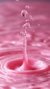 In a macro shot, a drop dissolves into pink water, forming a gentle blur of gradients as the liquid blends smoothly Royalty Free Stock Photo
