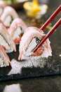Macro Shot of Eating Bacon Uramaki Sushi Rolls in Restaurant Closeup