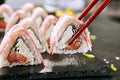 Macro Shot of Eating Bacon Uramaki Sushi Rolls in Restaurant Closeup