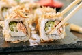 Macro Shot of Eating Katsuobushi Uramaki Sushi Rolls with Fried Salmon