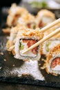 Macro Shot of Eating Katsuobushi Uramaki Sushi Rolls in Restaurant Closeup