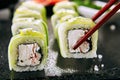 Macro Shot of Eating Snow Crab Uramaki Sushi Rolls in Japanese Restaurant