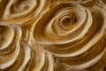 Macro shot of eroded sandstone texture, intricate wind-carved patterns forming delicate swirls.
