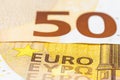 Macro shot of a European Union banknote of 50 EUR, close-up of the inscription EURO, selective focus.