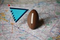 Macro shot of a flag and football placed on Nashville, Tennesee in a map