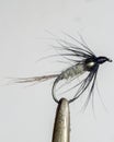 Macro shot of fly fishing lure on a black background, hand made fly for fishing Royalty Free Stock Photo