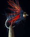 Macro shot of fly fishing lure on a black background, hand made fly for fishing Royalty Free Stock Photo