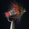 Macro shot of fly fishing lure on a black background, hand made fly for fishing Royalty Free Stock Photo