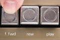 Finger pressed a forward button of a vintage tape recorder macro Royalty Free Stock Photo