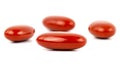 A macro shot of four red film-coated tablets arranged randomly, isolated on a white backgroundA macro shot of four red film-coated Royalty Free Stock Photo